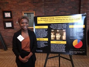 Sociology major Kitana Holland presents her research poster at Zyzzogeton.